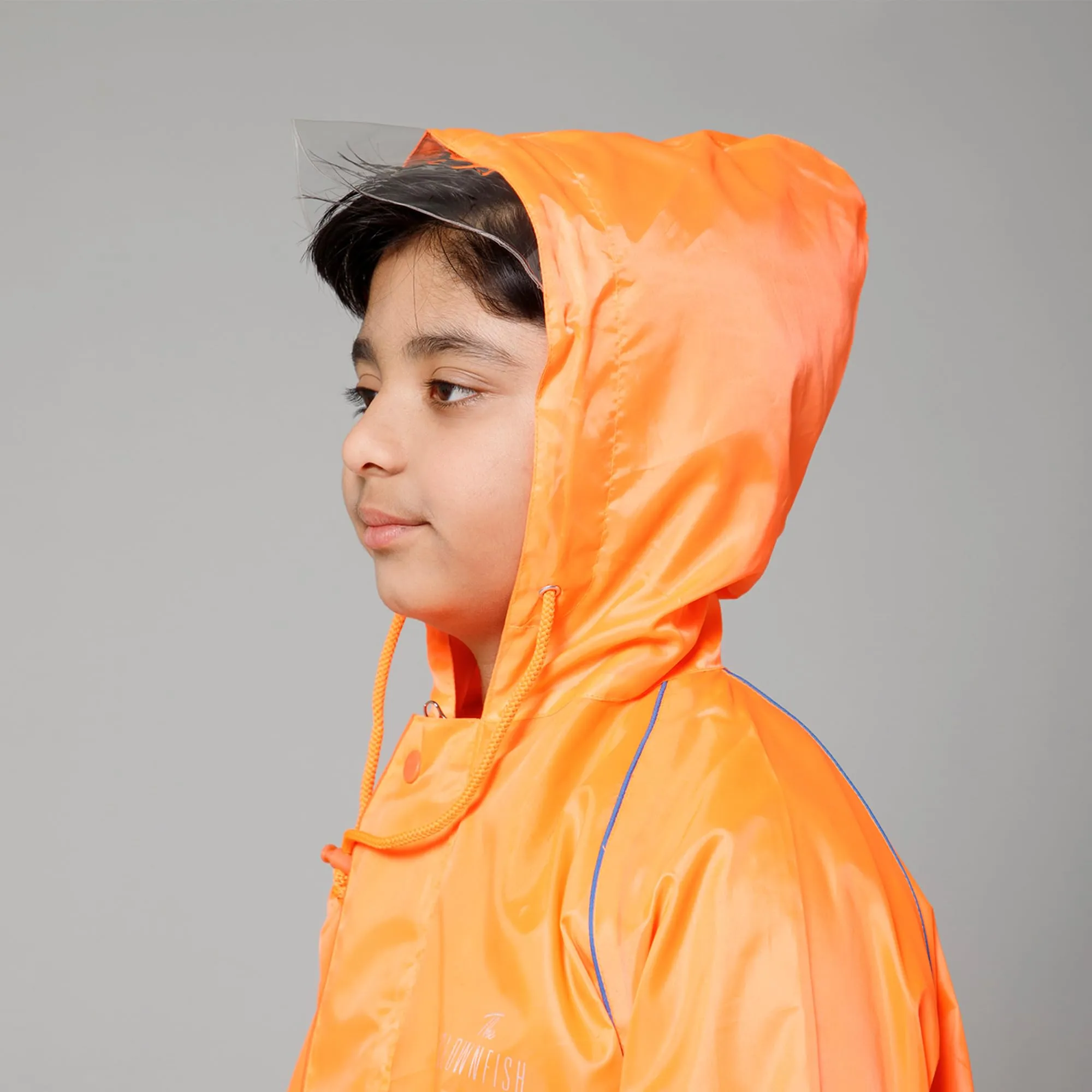 THE CLOWNFISH Duke Series Kids Waterproof Polyester Double Coating Reversible Raincoat with Hood and Reflector Logo at Back. Set of Top and Bottom. Printed Plastic Pouch. Kid Age-14-16 years (Orange)
