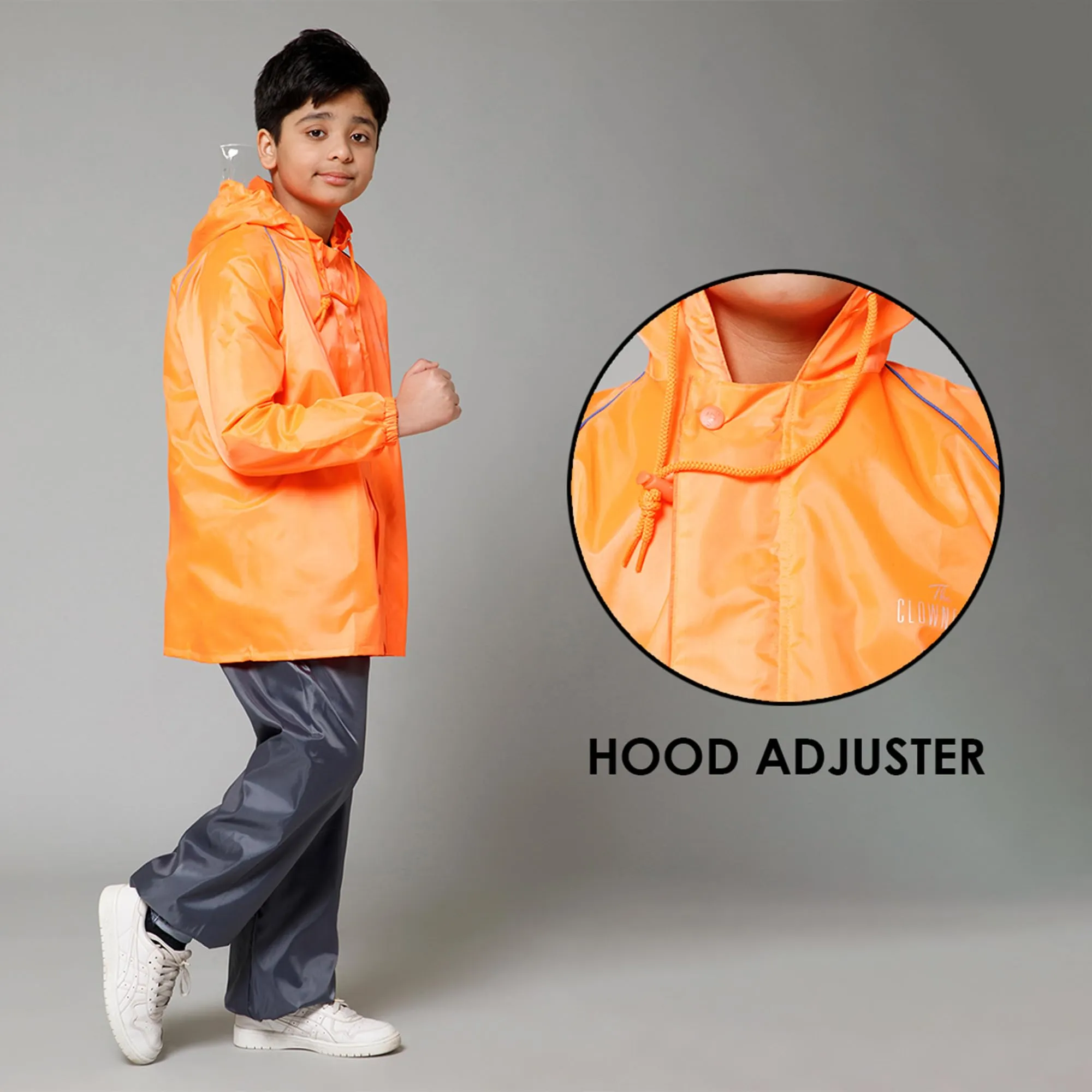THE CLOWNFISH Duke Series Kids Waterproof Polyester Double Coating Reversible Raincoat with Hood and Reflector Logo at Back. Set of Top and Bottom. Printed Plastic Pouch. Kid Age-14-16 years (Orange)
